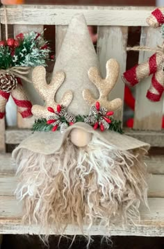 a christmas gnome sitting on top of a wooden chair