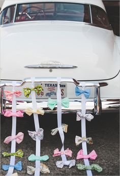 several bows tied to the back of an old car