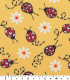 a yellow background with ladybugs and daisies on it, as well as a ruler