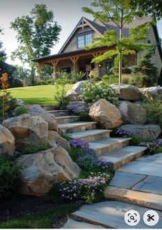 a house is shown with rocks and flowers in the front yard, along with steps leading up to it