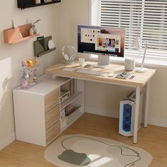 a computer desk with a monitor and keyboard on it in front of a white wall