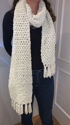 a woman wearing a white crocheted scarf