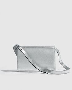 Silver metallic party bag with structured design, light and versatile. Vintage inspired.      

Made in bovine leather with metallic finish. 
Flap with magnetic clip closure.     
Adjustable and detachable long leather handle.
Open inside pocket. 
Designed and manufactured entirely in Spain using sustainable processes and small productions.
W17 cm x L25cm x D6 cm. Gold Handbag, Metallic Party, Structured Design, Handbag For Women, Gold Handbags, Design Light, Party Bag, Party Bags, New Instagram