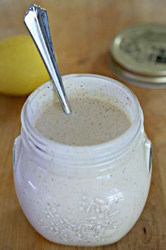 a spoon sticking out of a jar filled with liquid