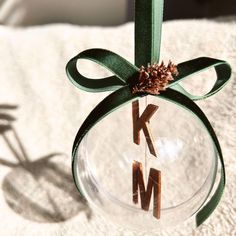 a glass ornament with the letter k on it