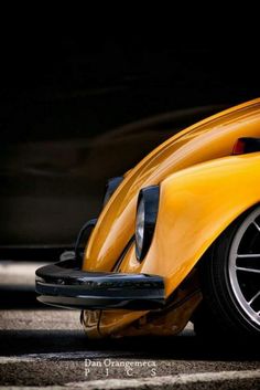 a yellow sports car is parked on the street