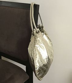 Attractive metallic gathered double-handle hobo bag.

Next-day processing. Shipped in 4-7 days. Gold Bucket Bag With Top Carry Handle, Gold Bucket Shoulder Bag With Top Carry Handle, Gold Shoulder Bucket Bag With Top Carry Handle, Gold Bucket Bag With Double Handle, Gold Double Handle Bucket Bag For Everyday Use, Metallic Shoulder Bag For Shopping, Metallic Double Handle Everyday Bag, Metallic Double Handle Bag For Shopping, Metallic Bags With Adjustable Strap For Daily Use