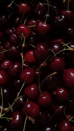 a pile of cherries sitting on top of each other