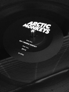 an old record player with the arctic monkeys logo on it's side, in black and white