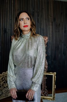 This long sleeve blouse in champagne features a shimmery metallic fabric, long sleeves, and mock neck design, making it the perfect statement piece for any occasion. Color: gold Material: polyester, spandex Fit: true to size Metallic Fabric, Gold Material, Neck Designs, Statement Pieces, Mock Neck, Polyester Spandex, Shirts Tops, Sleeve Blouse, Champagne