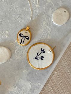 three decorated cookies sitting on top of a table