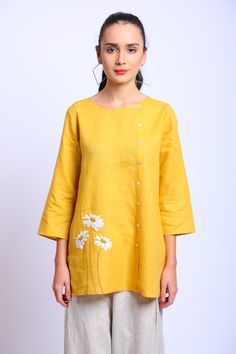 Ochre yellow short hem tunic in linen base fabric with floral motif embroidery and side button placket.
Components:1
Pattern:Embroidered
Type of Work:Floral Motifs
Neckline:Round
Sleeve Length:Three Quarter
Fabric:100% Linen
Color:Yellow
Other Details:
Floral motif embroidery
Side button down placket
Note: The pant worn by the model is not for sale
Occasion:Work - Aza Fashions Linen Tunics For Women, Motif Embroidery, Tunics Online, Ochre Yellow, Buy Linen, Yellow Short, Linen Color, Linen Tunic, Yellow Shorts