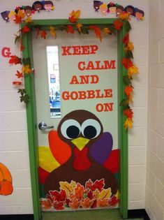 a door decorated to look like a turkey with leaves around it and the words keep calm and gobble on