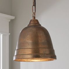 an old fashioned light hanging from a ceiling