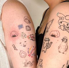 two women with tattoos on their arms, one is holding the other's arm