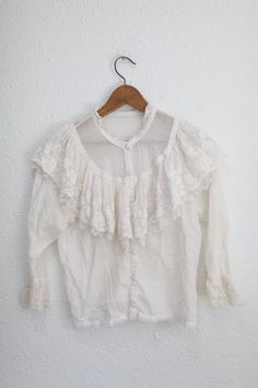 "material: cotton & lace used vintage condition.  shoulders:14 1/2 \" approx pit to pit:19 1/2\" sleeve:19\" length:21\"" Vintage White Lace Top For Spring, Lace Tops With Ruffled Collar For Daywear, Lace Top With Ruffled Collar For Daywear, Vintage Lace Patchwork Top For Spring, Vintage Lace Blouse With Ruffled Collar, Spring Vintage Lace Top With Lace Trim, Vintage Lace Top With Lace Trim For Spring, Fitted Cotton Lace Top With Ruffles, Vintage Lace Top With Ruffles