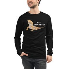 Fans of Bearded Dragons will love this cute, funny drawing of a Beardie asking for his favorite snack, crickets! Unisex sizing for both men and women. Versatile and comfortable, this Bella + Canvas long sleeve tee is the perfect addition to anyone's wardrobe. * 100% combed and ring-spun cotton * Heather colors are 52% combed and ring-spun cotton, 48% polyester * Athletic Heather is 90% combed and ring-spun cotton, 10% polyester * 32 singles * Retail fit * Crew neck * Cover-stitched collar * 2'' Novelty Long Sleeve T-shirt With Graphic Print, Funny Long Sleeve Black T-shirt, Funny Long Sleeve T-shirt With Text, Dragon Gifts, Beard Humor, Dragon Shirt, Neck Cover, Funny Drawings, Bearded Dragon