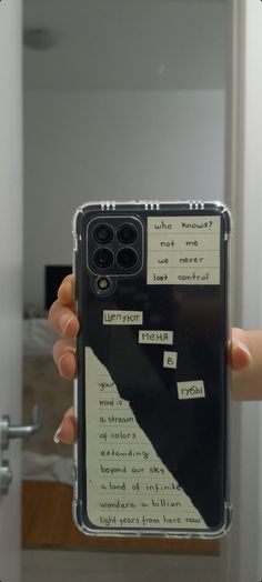 someone holding up their phone case with notes on it