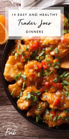 a skillet filled with chicken and vegetables on top of a wooden table next to an orange