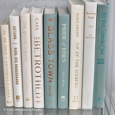 several books are lined up on a shelf