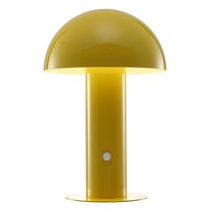 a yellow table lamp sitting on top of a white floor