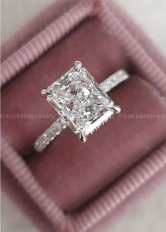 a princess cut diamond ring in a velvet box