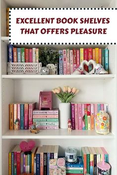 a book shelf filled with lots of books next to a white vase and pink flowers