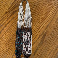 This Unique Necklace Showcases The Rich Cultural Heritage Of The Navajo People. The Handcrafted Beaded Design Features Turquoise, Shells, And Seed Beads In A Stunning White, Brown And Black Palette. The Necklace Is 31 Inches Long And Secured With A 925 Sterling Silver Clasp.Perfect For Graduation Or Any Special Occasion, This Unisex Necklace Is A Rare Find That Will Add A Touch Of Ethnic And Regional Style To Any Outfit. The Woven Design Adds An Extra Layer Of Complexity And Elegance To The Piece, Making It A True Work Of Art. Don't Miss Out On The Opportunity To Own This Exquisite Native American Necklace. It Was Purchased Onsite At Canyon De Chellyin The Mid 90s. Canyon De Chelly, Black Palette, Native American Necklace, Mid 90s, Bead Weaving Patterns, Unisex Necklace, Native Jewelry, Unique Necklace, Woven Design