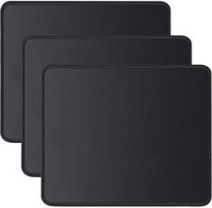 three black mousepads sitting next to each other