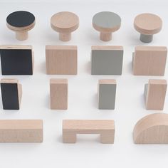 various wooden objects are arranged on a white surface