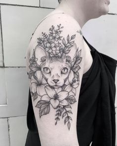 a woman with a cat and flowers on her arm