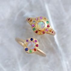 Our pebble collection of raw, rough, beaten metals set with precious gems. Perfectly imperfect and all one of a kind. An off shape pebble ring set with an Australian crystal opal surrounded by various shades of Sapphires, Ruby and Emerald (or tsavorite garnet). Opal measures 4.5mm Band width 1.6mm. Weight 3.5g (approximately). Sarah Gardner, Jewellery Wishlist, Roman Ring, Magical Crystal, Pebble Ring, Dope Makeup, Tsavorite Garnet, Crystal Opal, Precious Gems