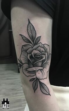 a black and white rose tattoo on the arm