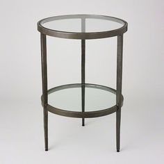 a round glass table with metal legs