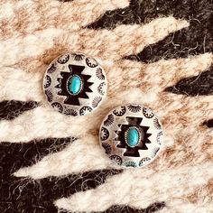 The Concho Style Aztec Silver stamped post back earrings feature a small turquoise stone inlayed in the center. The tribal Aztec stamp design around the edge makes these earrings pop. The Aztec design is black and makes the small turquoise stone stand out.  These earrings are 1 in diameter. Aztec Design, Aztec Designs, Stone Inlay, Shopify Theme, Stamp Design, Turquoise Stone, The Edge, Stamp, Turquoise