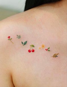 the back of a woman's shoulder with small flowers and leaves painted on it