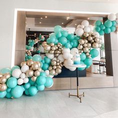 there is a balloon arch in the middle of the room with balloons all over it