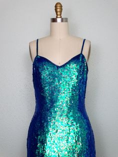 "This is an amazing little dress embellished all over with iridescent color-changing sequins. The sequins change colors with movement and in different light.. giving off hues of bright blue, green, turquoise and teal ..all shades! It's also accented with glass beading. This show-stopper is in perfect condition! Bust - 34/36\" Waist - 26/28\" Hips - 36/38\" Dress Length - 35\" Tag Size - US 6 This dress comes from a pet-free and smoke-free home. If you would like more info or have any questions, Iridescent Clothing, Iridescent Sequin Dress, Rocker Glam, Turquoise And Teal, Disco Queen, Vintage Party Dress, Iridescent Mermaid, Iridescent Dress, Blue Green Turquoise