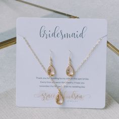 the bridesmaid necklace and earring set is on display in front of a card