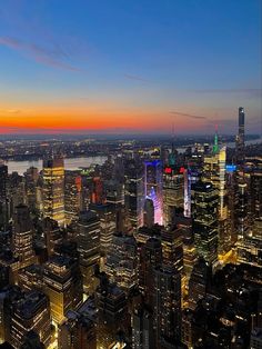 an aerial view of the city skyline at night, including skyscrapers and other tall buildings