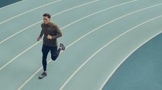 a man running on a blue track