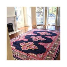 an image of a rug on the floor in front of a fire place and window