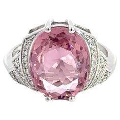 Ring (Matching Earrings Available) 18K White Gold  Weight 4,75 GMS Tourmaline -1/4.86 Cts   Diamond-38/0.129 Cts Size-52 Step back in time with this exquisite Art Deco-inspired ring, elegantly fashioned from 4.75 grams of 18k white gold. This refined piece features a central 4.86-carat pink tourmaline, radiating with vibrant hues that capture the spirit of the roaring twenties. Surrounding this stunning gem are 38 round diamonds, totaling 0.129 carats, that add a sparkling brilliance to the piece. Sized at 52, this ring combines vintage charm with a touch of modern luxury, making it a perfect addition to any sophisticated jewelry collection. With a heritage of ancient fine Swiss jewelry traditions, NATKINA is a Geneva based jewellery brand, which creates modern jewellery masterpieces suita Luxury Tourmaline White Gold Jewelry, The Roaring Twenties, Ring Matching, Sophisticated Jewelry, Pink Sparkle, Roaring Twenties, Step Back, Art Deco Inspired, Inspiration Art