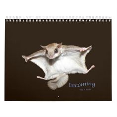 a small mouse flying through the air on top of a calendar