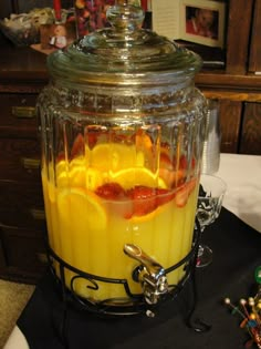 a blender filled with orange juice on top of a table