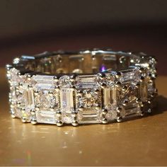 a diamond ring sitting on top of a wooden table