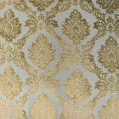 an upholstered blue and gold wallpaper with ornate designs on the back ground