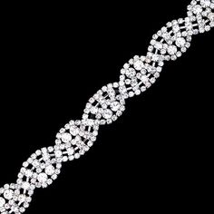 a white diamond bracelet on a black background