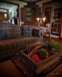 a living room filled with furniture and a wooden box on top of a coffee table