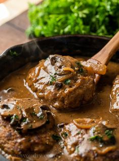 a skillet filled with meatballs and gravy